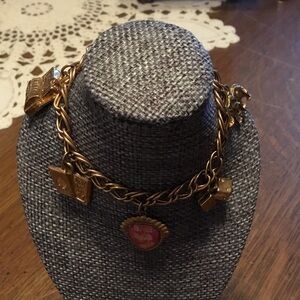 Gold tone bracelet with charms